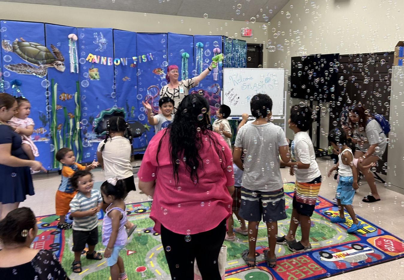 Families and children playing with bubbles at a neighborhood gathering