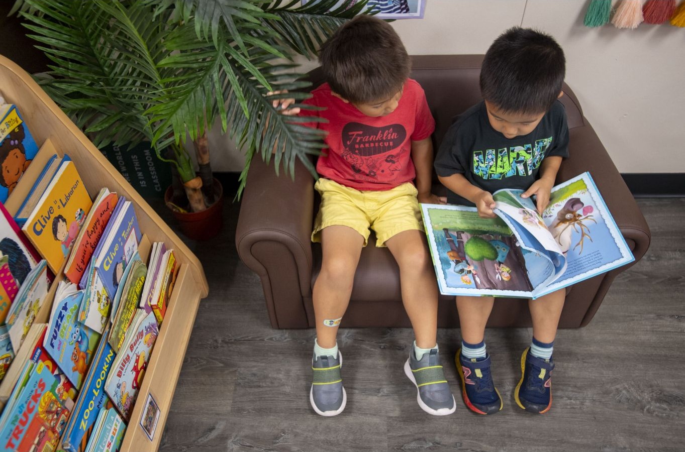 Two children looking at a picture book together